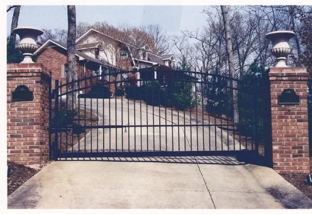 Black arched gate between brick columns - Elantra Gate Systems