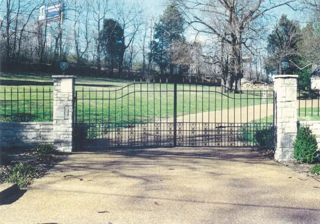 Scroll-panel arched driveway gate with lanterns - Elantra Gate Systems